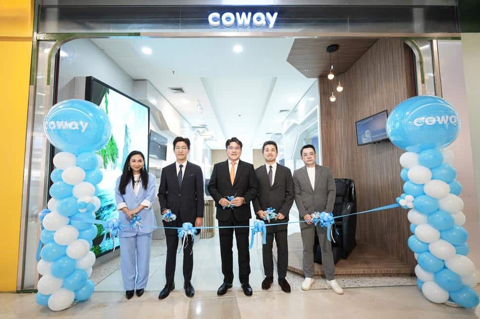 A group of people standing in front of a ribbon
Description automatically generated